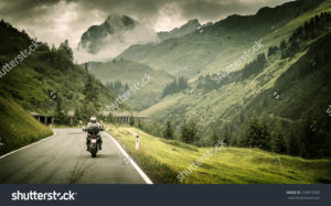 stock photo motorcyclist on mountainous highway cold overcast weather europe austria alps extreme sport 153813350